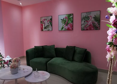 Sala com sofá verde e decoração floral no Rostos em Luanda, Luanda, AO.