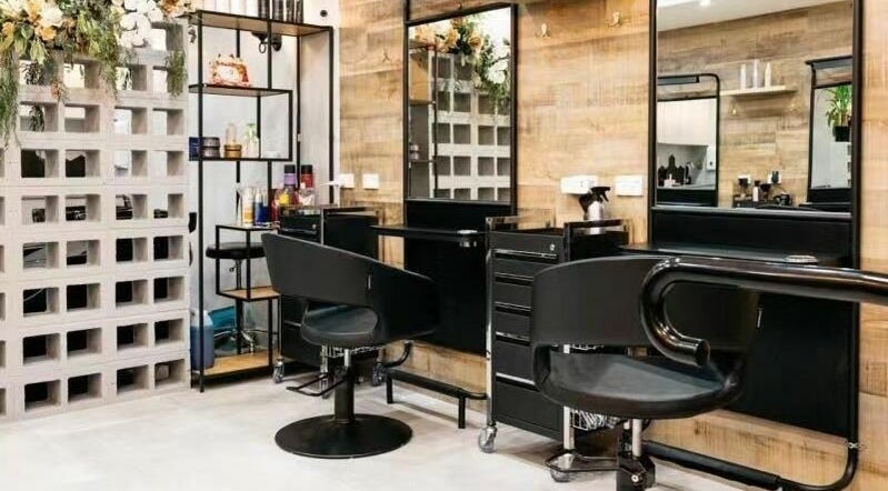 Modern salon setup at Perfect Hairdressing Maroubra, Maroubra, NSW, AU with elegant black styling chairs.