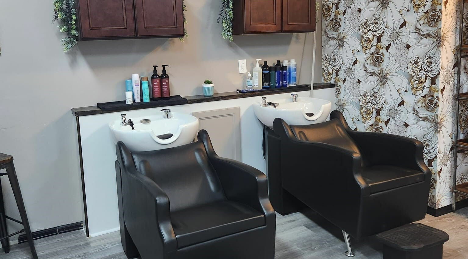 Stylish wash stations at Revival Hair Studio in Onsted, Michigan, US, displaying luxury hair care products.