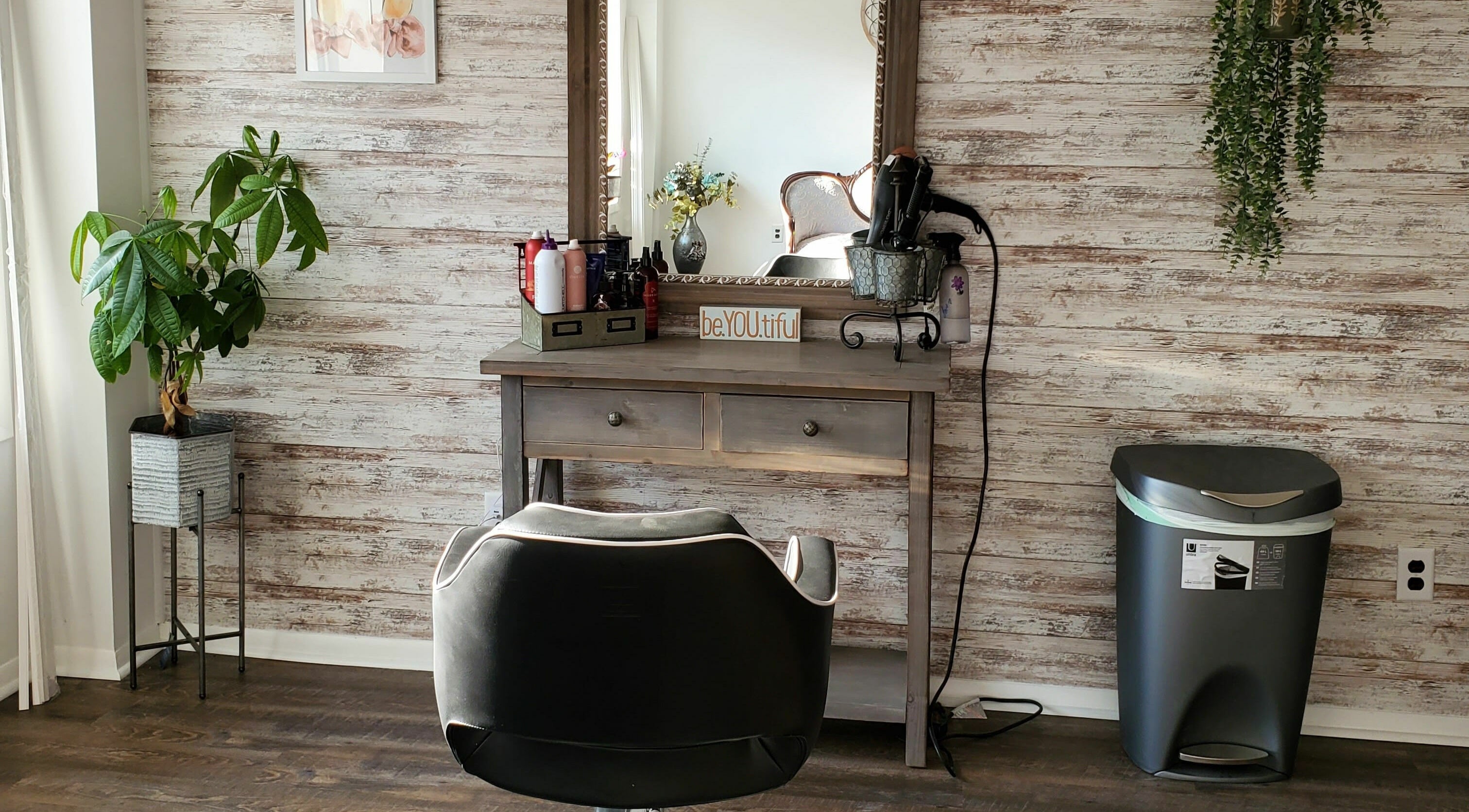 Stylish salon station at Revival Hair Studio in Onsted, Michigan, US, featuring elegant decor and beauty products.