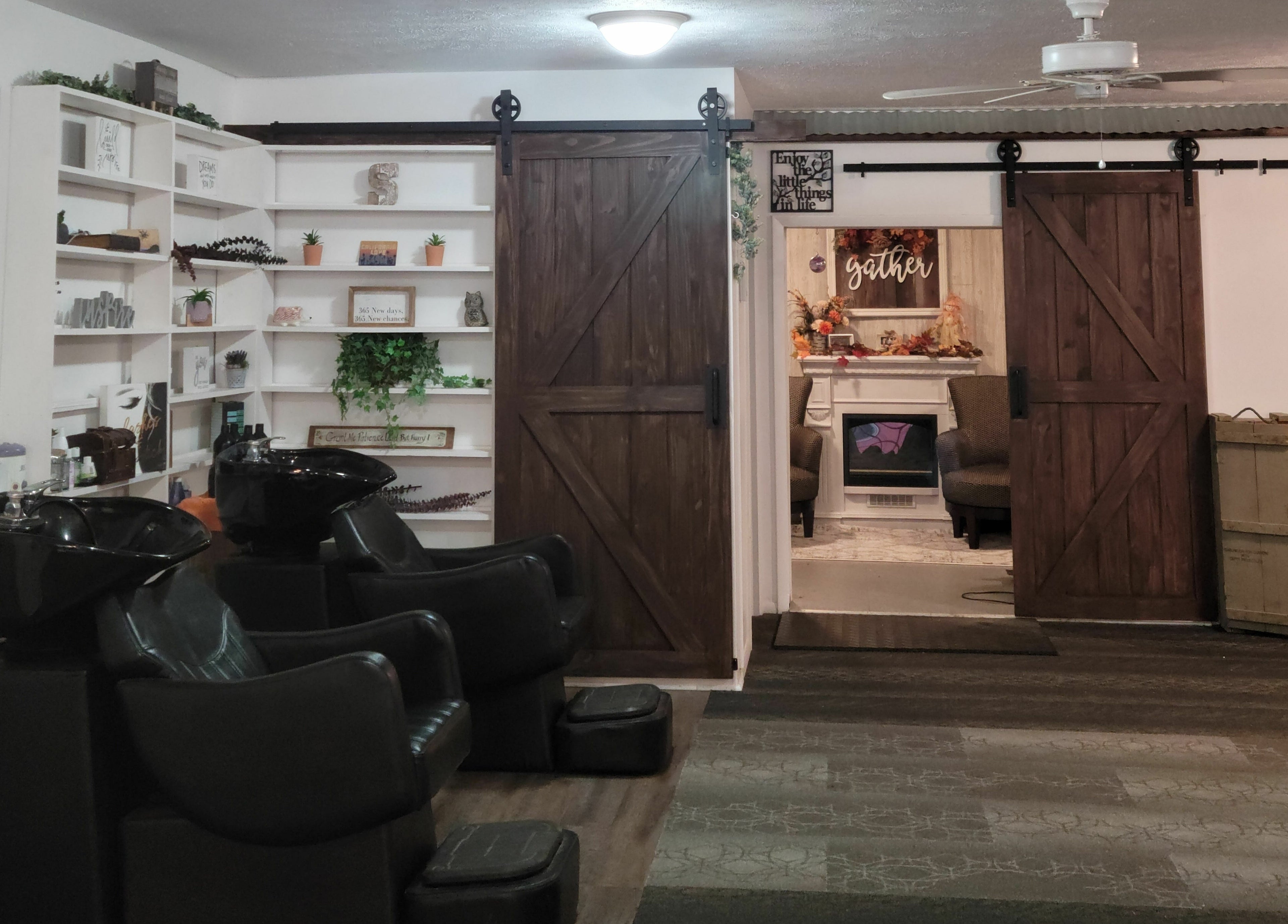 Interior view of Revival Hair Studio in Onsted, Michigan, US, showcasing stylish salon chairs and rustic decor.