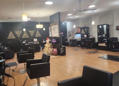 Elegant interior of Starrlight Beauty in Minerva, Ohio, US featuring modern salon chairs and stylish lighting.