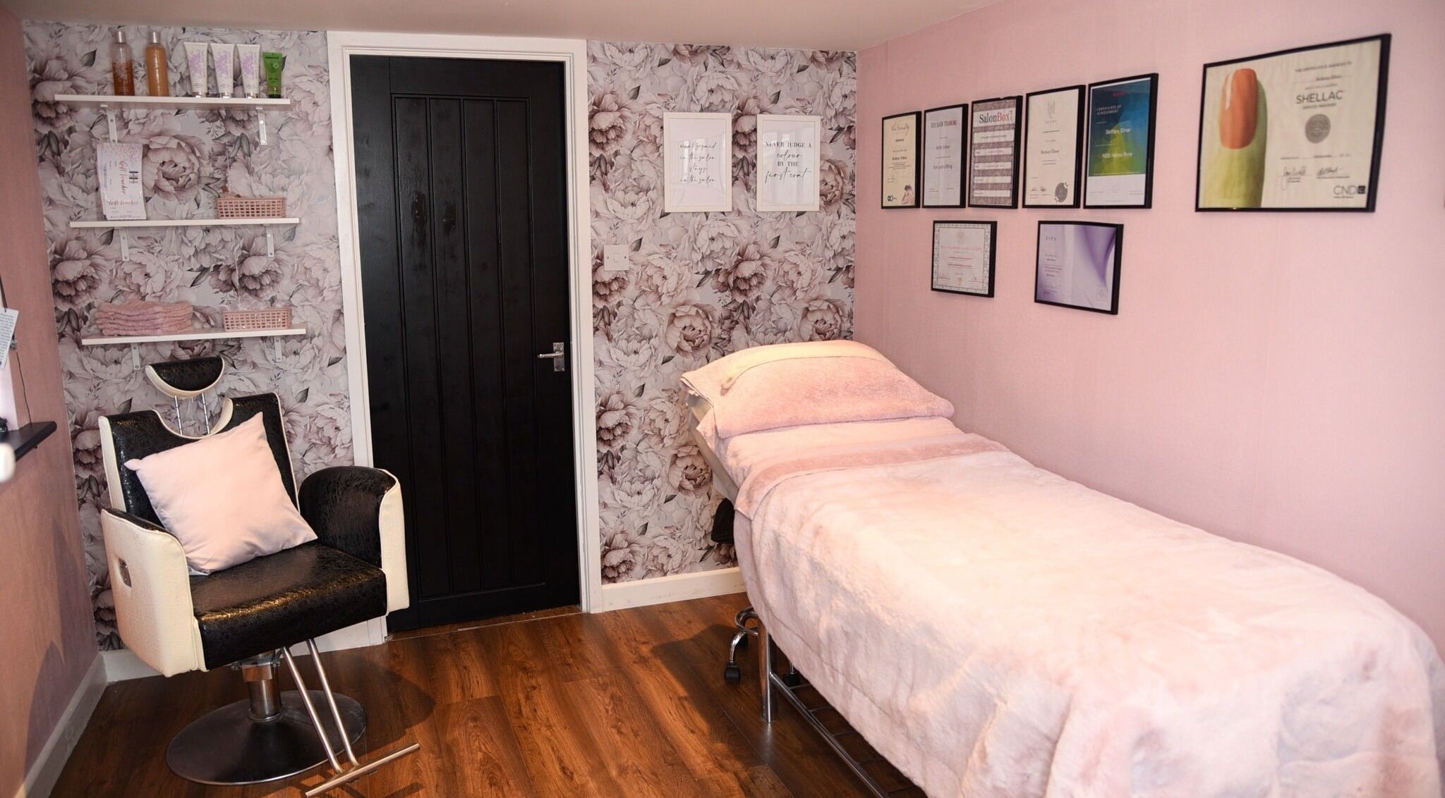 Elegant Beauty's cozy spa room in Brackley, England, GB with floral decor and a treatment bed.