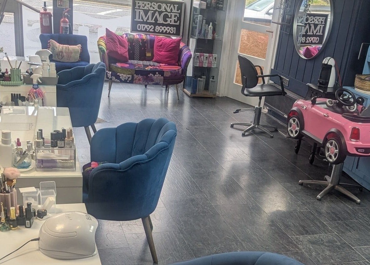 Chic salon interior at Personal Image, Gorseinon, Wales, GB, featuring stylish chairs and beauty products display.