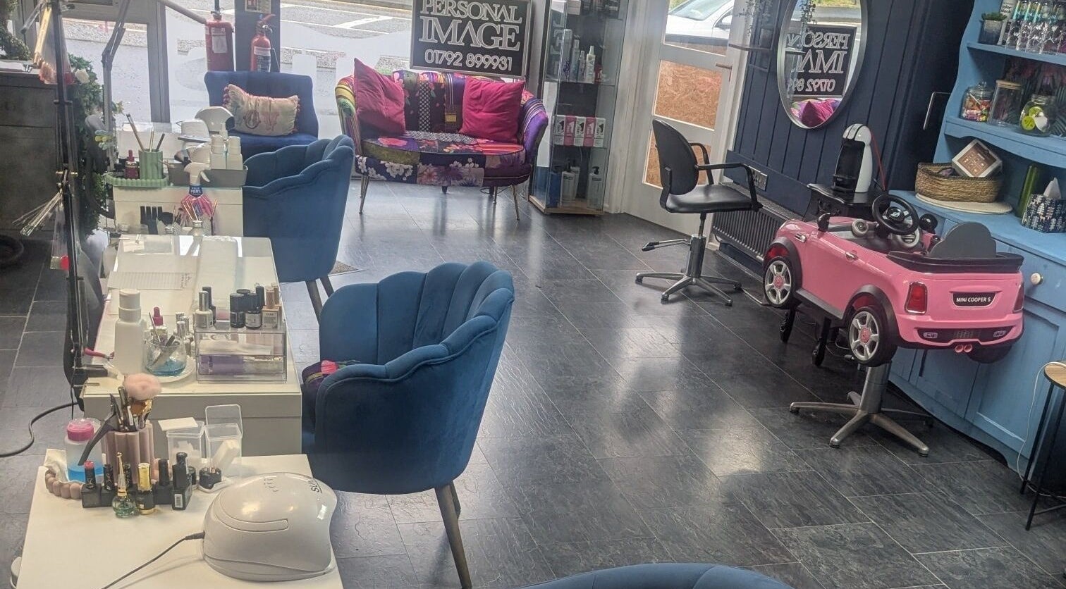 Chic salon interior at Personal Image, Gorseinon, Wales, GB, featuring stylish chairs and beauty products display.