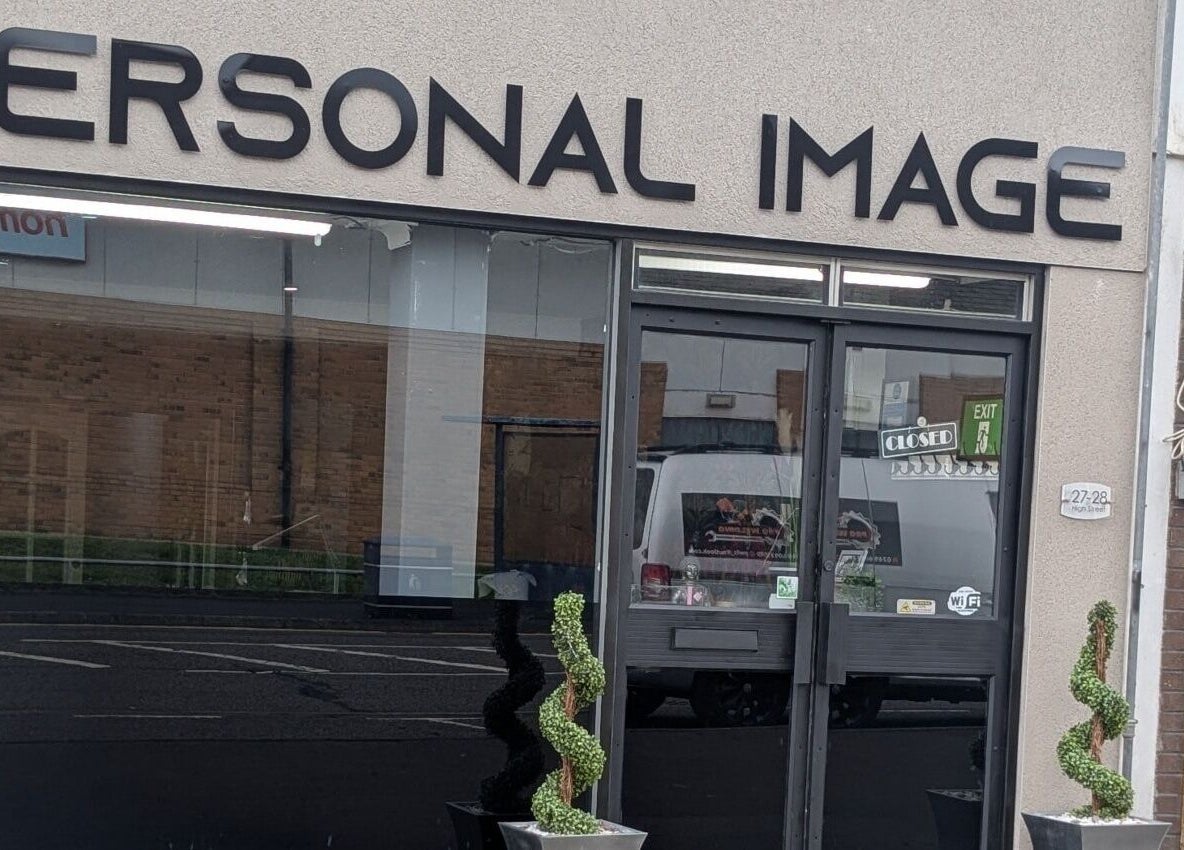 Front view of Personal Image salon in Gorseinon, Wales, GB with decorative plants by the door.