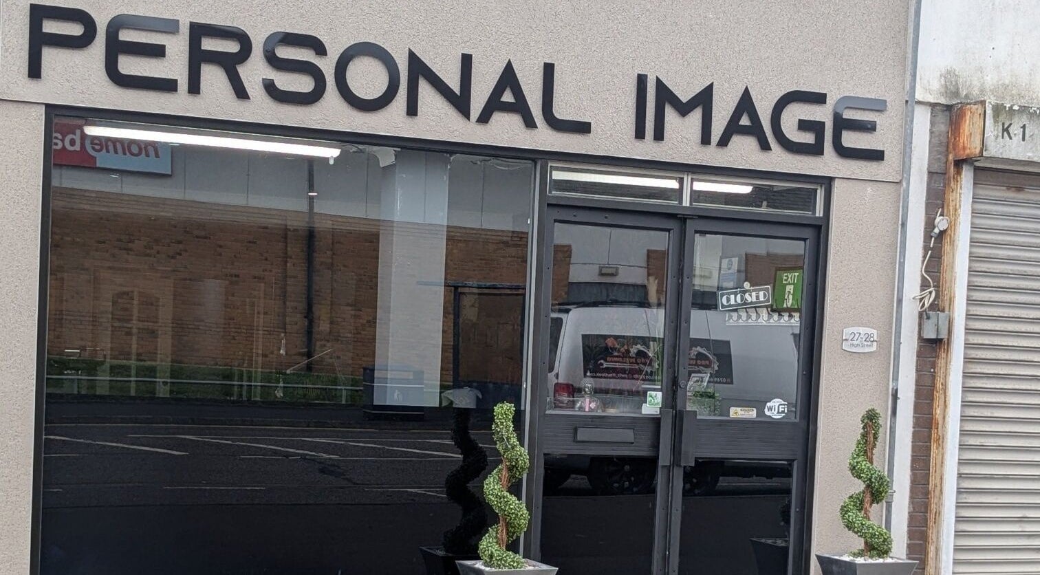 Front view of Personal Image salon in Gorseinon, Wales, GB with decorative plants by the door.