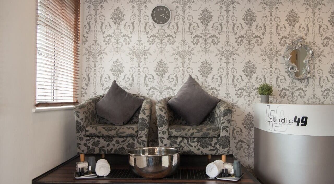 Elegant seating area in Studio 49, Alresford, England, GB with floral chairs and a stylish ambiance.