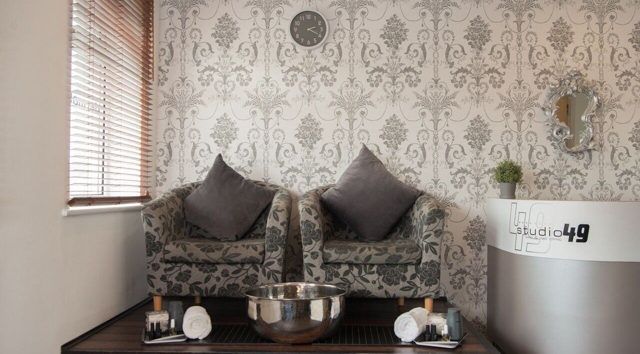 Elegant seating area in Studio 49, Alresford, England, GB with floral chairs and a stylish ambiance.