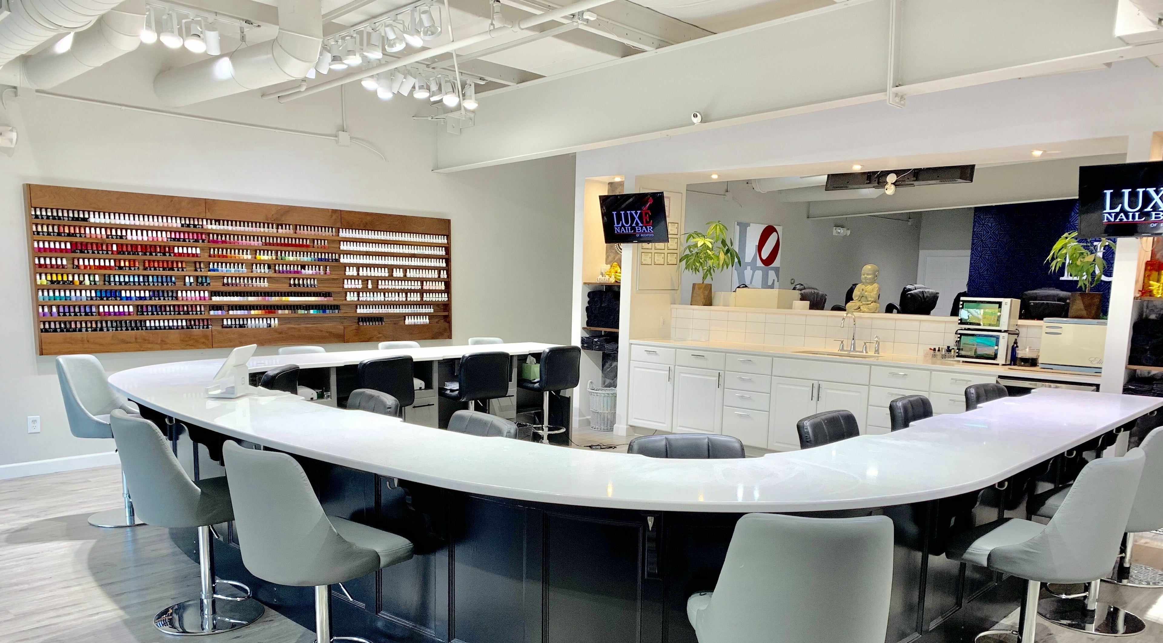 Modern interior of Luxe Nail Bar of Rockford located in Rockford, Illinois, US with elegant seating and polish display.