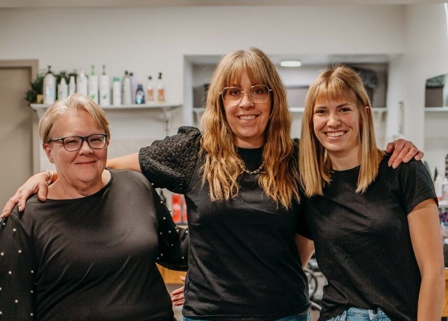 Friendly staff at The Curly Temple Salon in Burns Lake, British Columbia, CA, welcoming clients with warm smiles.