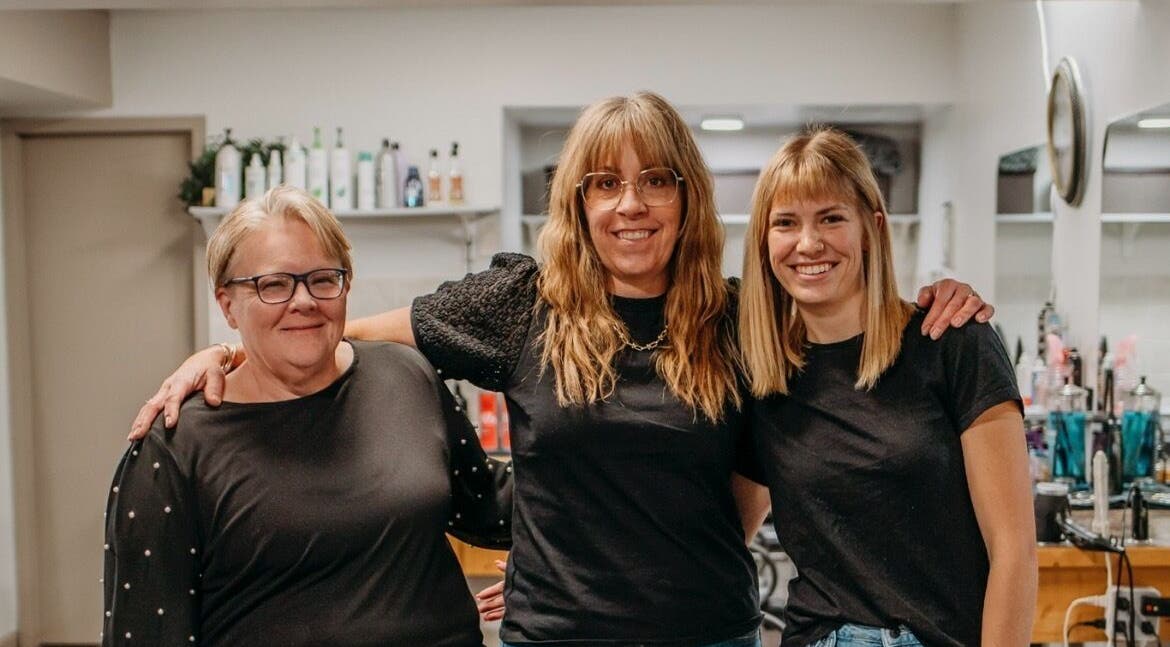 Friendly staff at The Curly Temple Salon in Burns Lake, British Columbia, CA, welcoming clients with warm smiles.