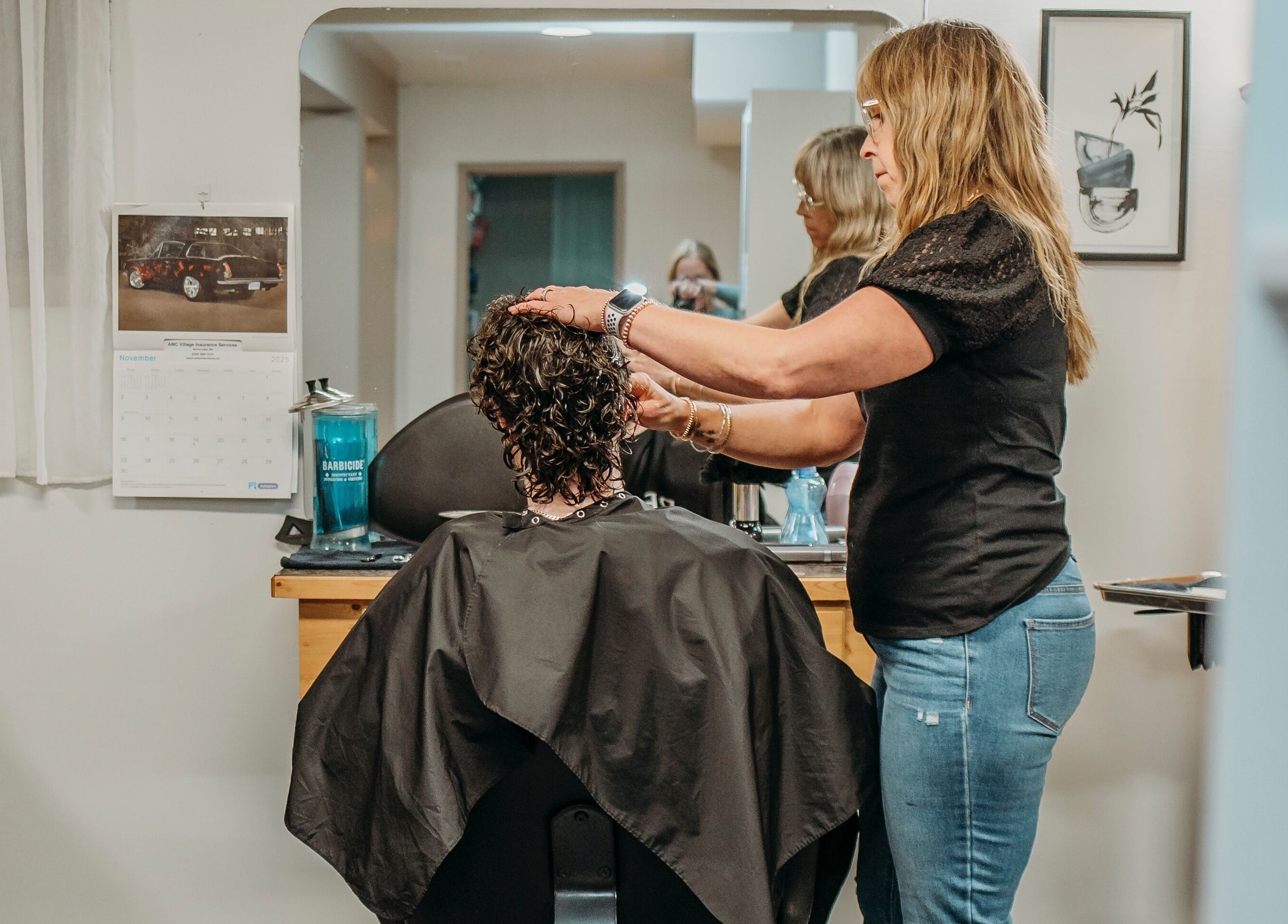 Stylist working on curly hair at The Curly Temple Salon in Burns Lake, British Columbia, CA.