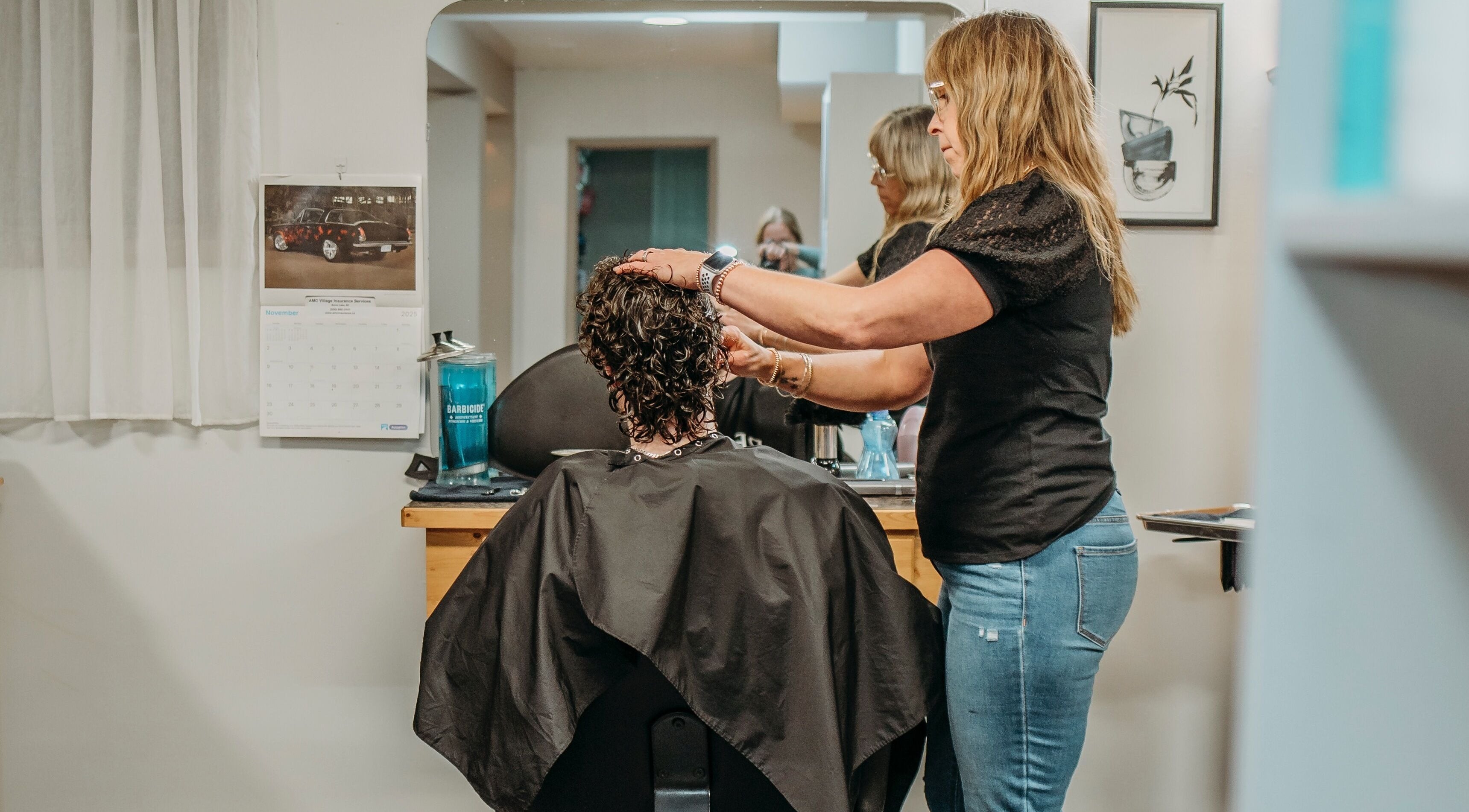 Stylist working on curly hair at The Curly Temple Salon in Burns Lake, British Columbia, CA.