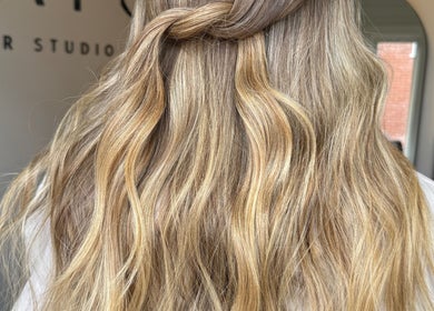 Stylish wavy hairstyle at Seats Hair Studio in Leicester, England, GB. Blonde hair with intricate braid.
