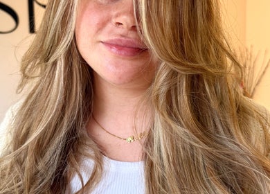 Woman with styled blonde hair at Seats Hair Studio, Leicester, England, GB, showcasing chic salon results.