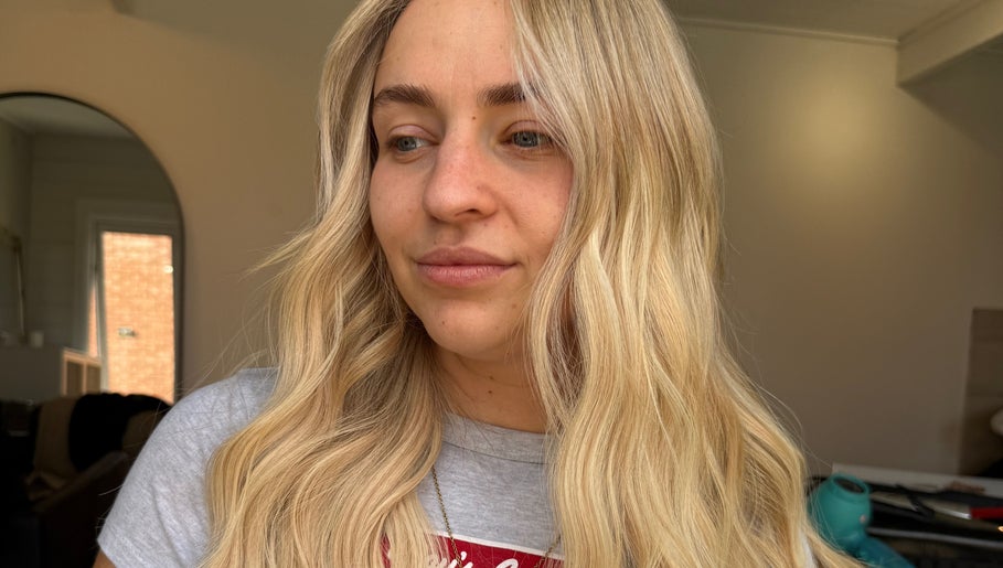 Close-up of a woman with blonde hair styled at TIEGAN SEATON (Seats Hair Studio), Anstey, England, GB.