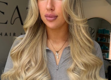 Blonde hair with elegant waves at TIEGAN SEATON (Seats Hair Studio), Anstey, England, GB.