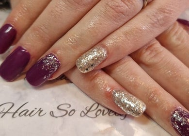Stylish purple and silver glitter nails at Beauty and Hair So Lovely, Braunstone Town, England, GB.