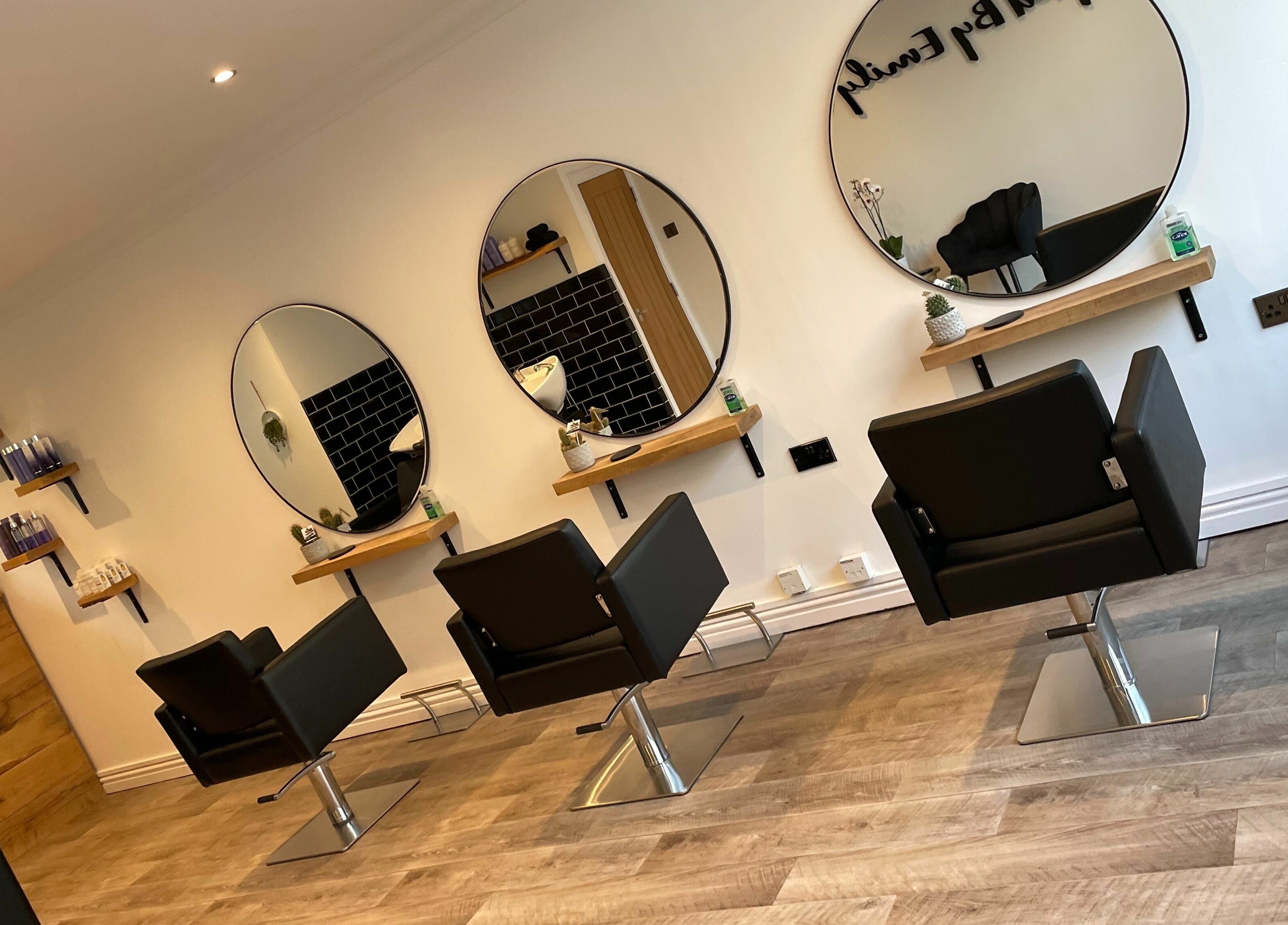 Chic salon interior of Styled By Emily LTD in Darwen, England featuring stylish mirrors and modern chairs.