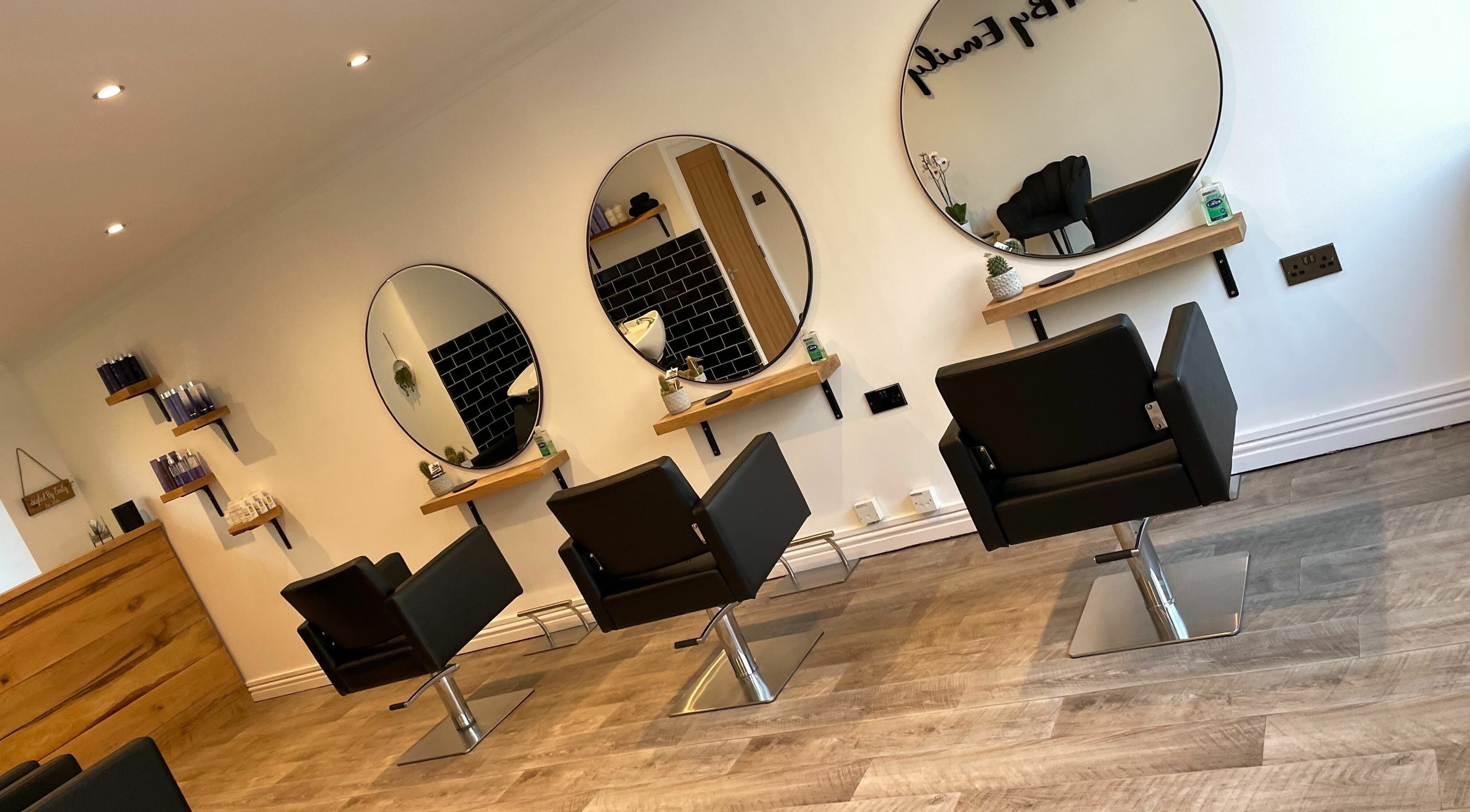 Chic salon interior of Styled By Emily LTD in Darwen, England featuring stylish mirrors and modern chairs.