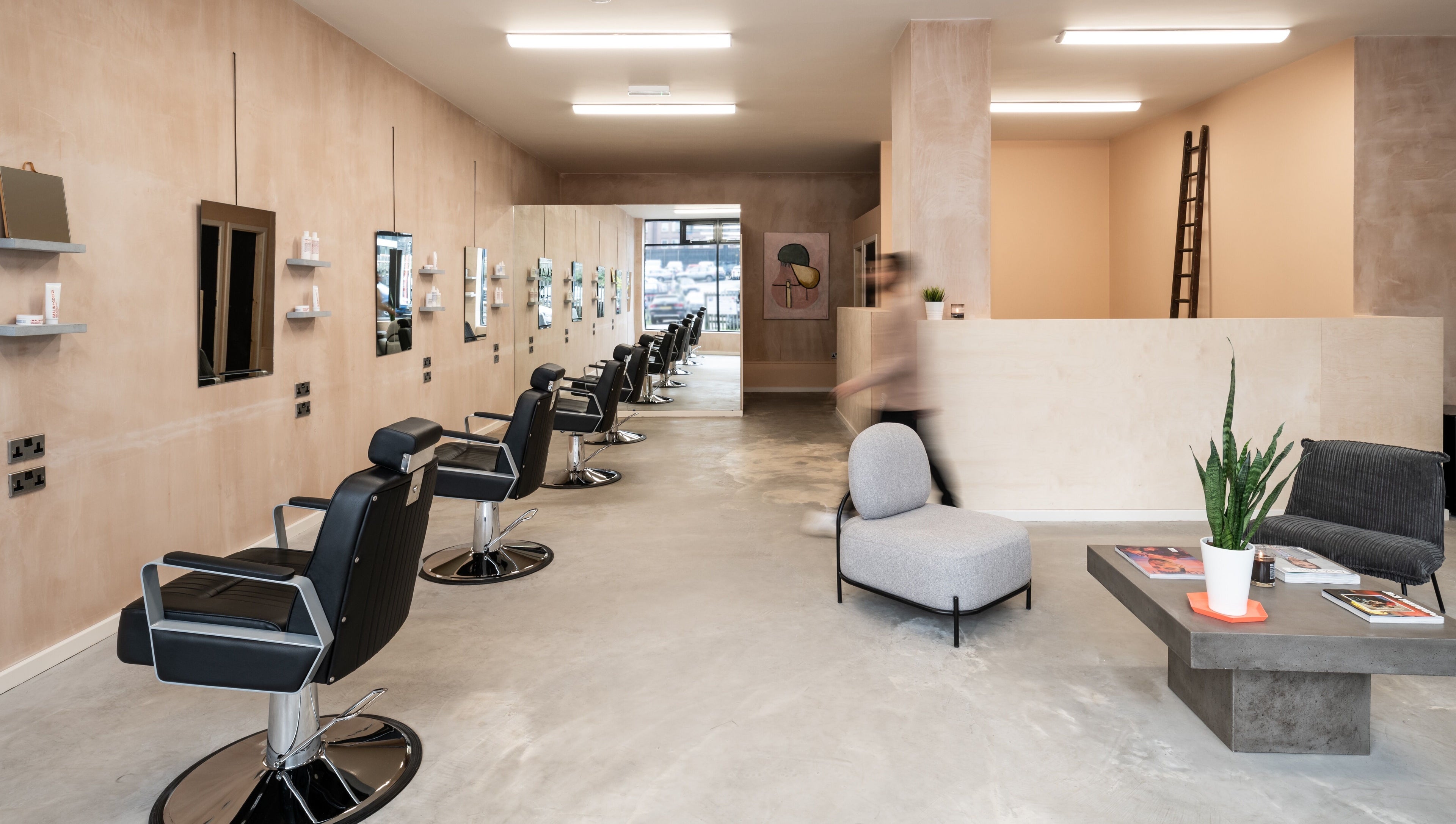 Sleek interior of BLACC + BLOND in Birmingham, England, GB, featuring modern salon chairs and minimalist decor.