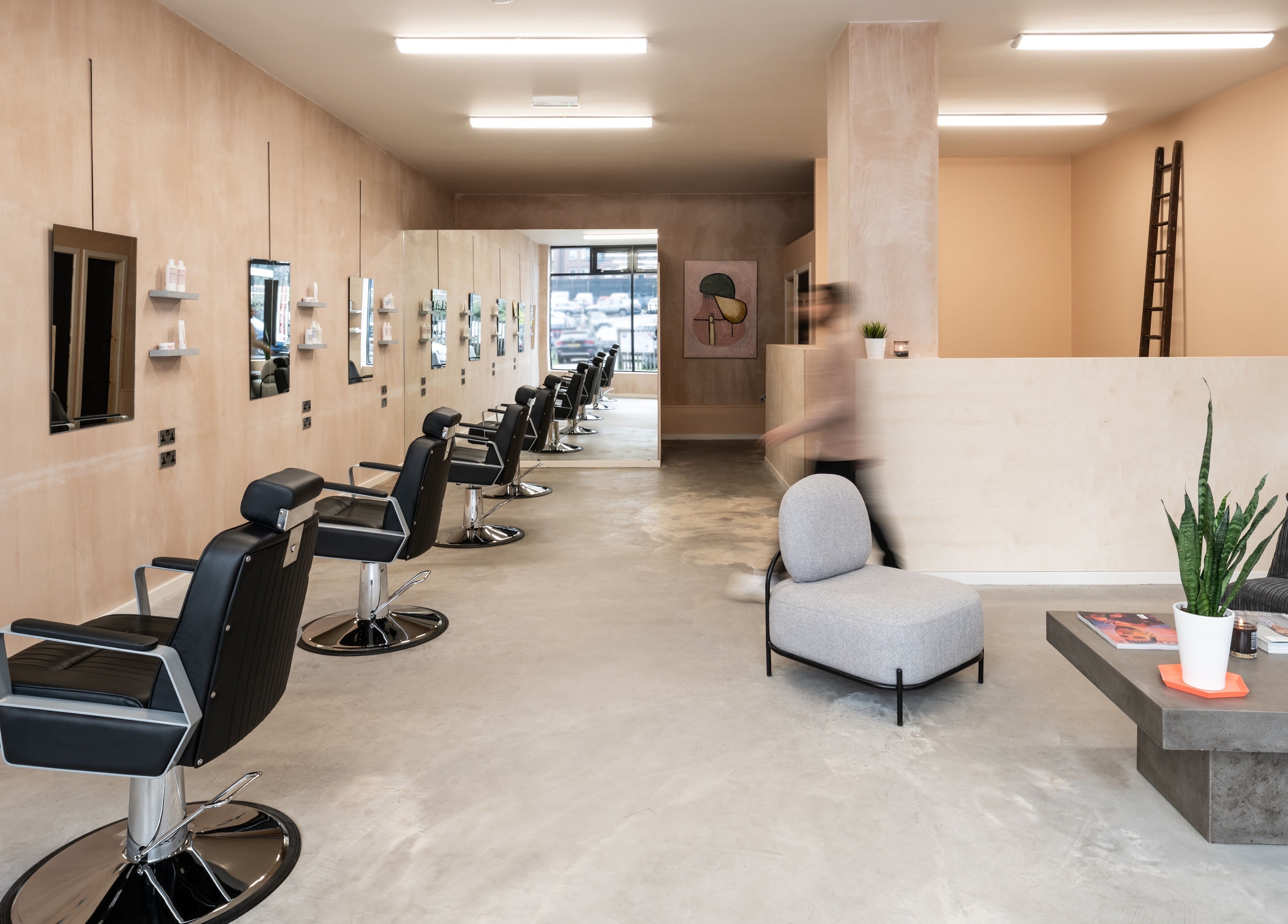 Sleek interior of BLACC + BLOND in Birmingham, England, GB, featuring modern salon chairs and minimalist decor.