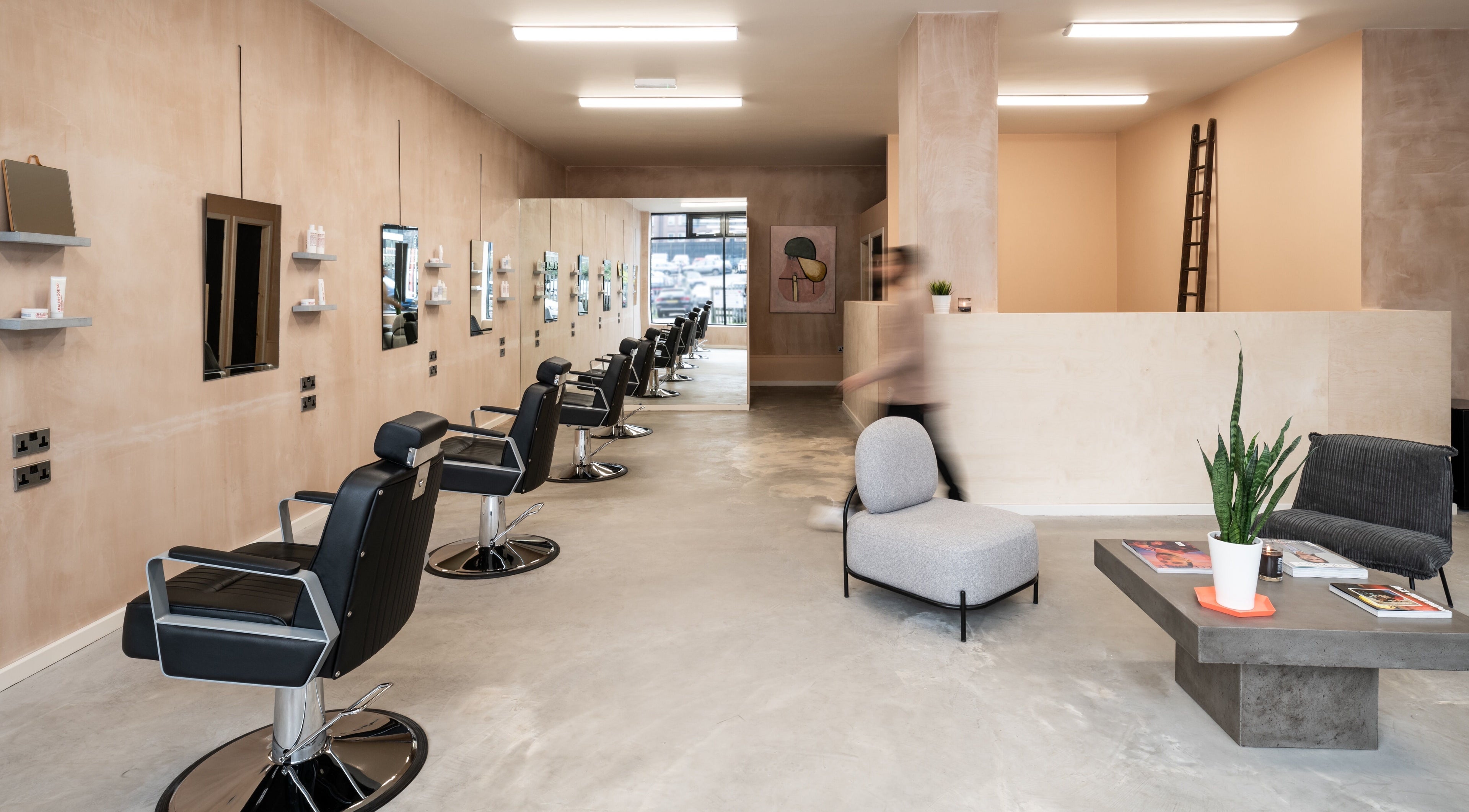 Sleek interior of BLACC + BLOND in Birmingham, England, GB, featuring modern salon chairs and minimalist decor.