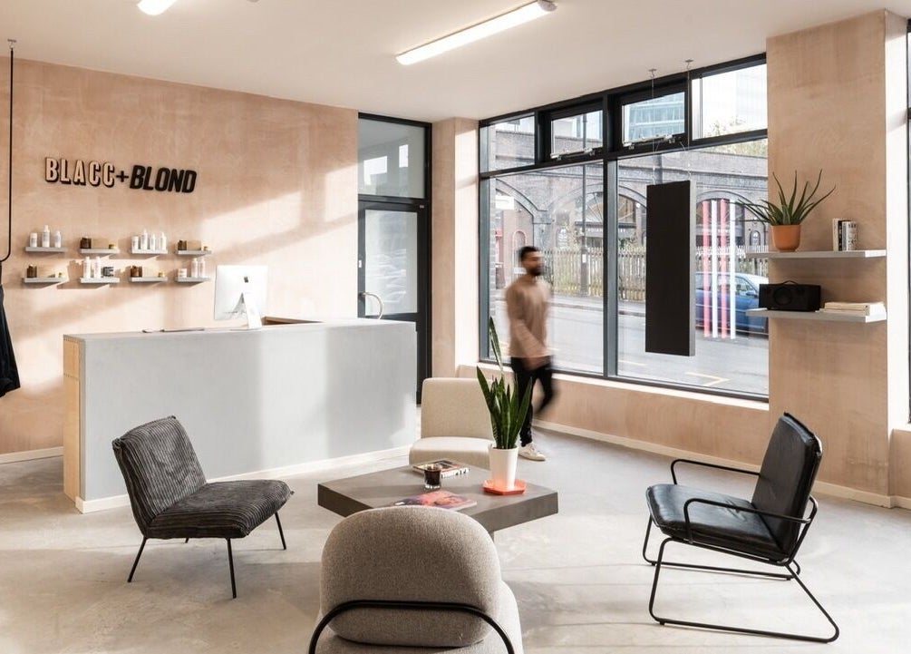 Modern interior of BLACC + BLOND, Birmingham, England, GB with sleek design and comfortable seating.