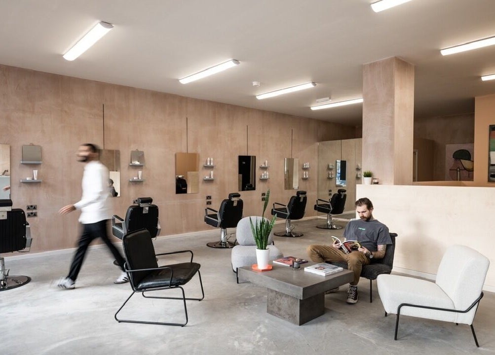 BLACC + BLOND salon interior, featuring modern chairs and decor in Birmingham, England, GB.