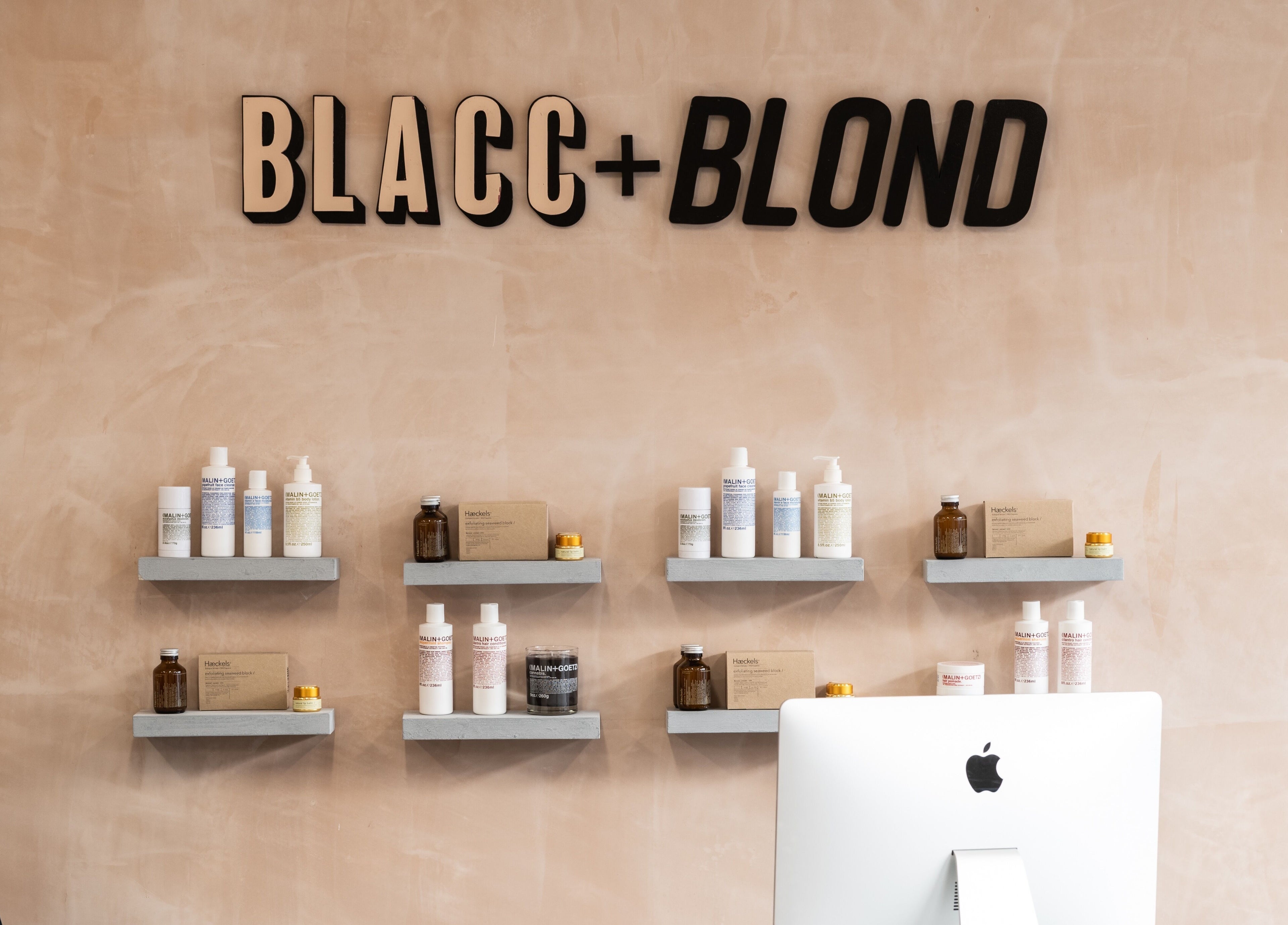 Product shelves at BLACC + BLOND in Birmingham, England, GB showcasing beauty items with stylish decor.