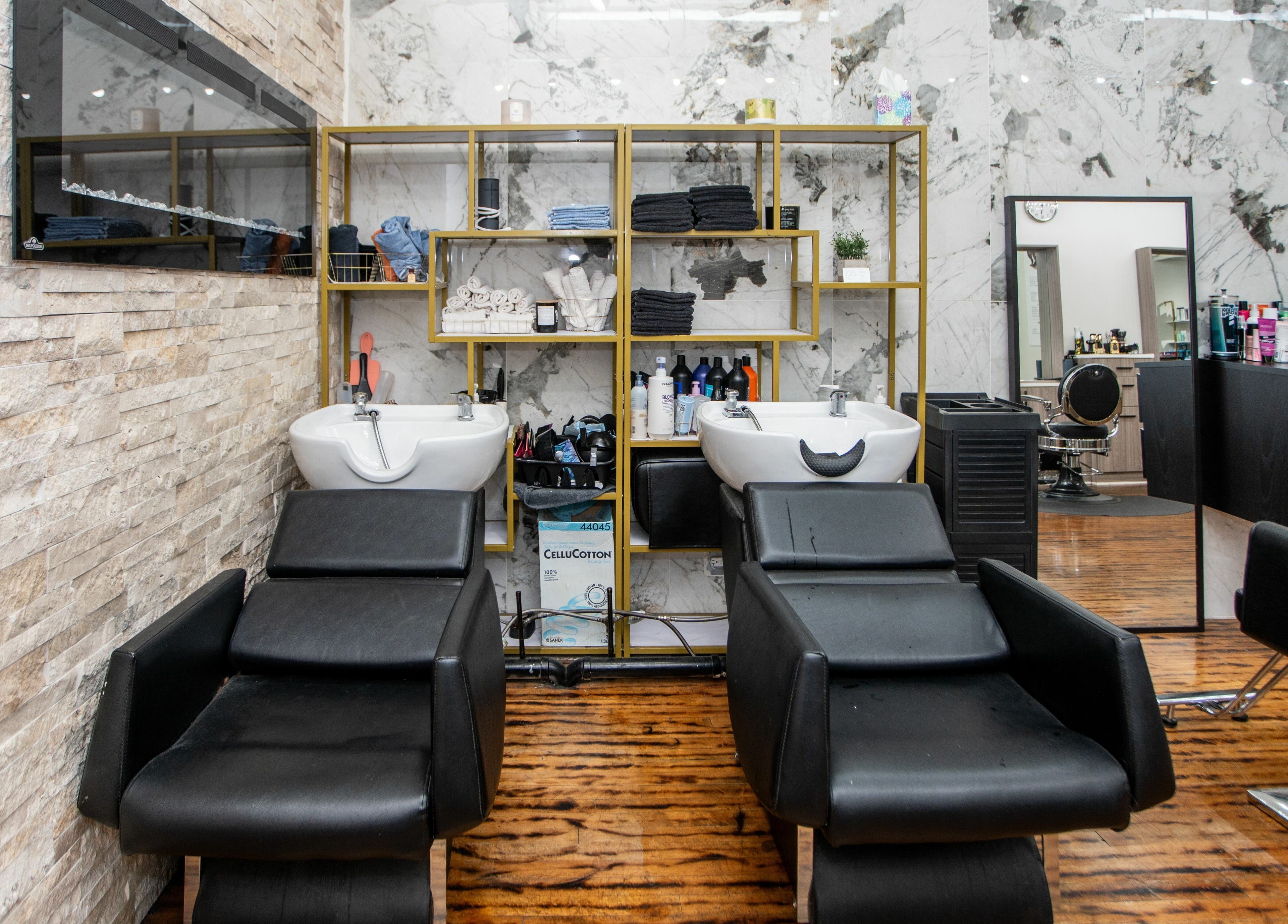 Elegant wash station at Scissor's Palace, Evanston, Illinois, US, with plush chairs and modern design.