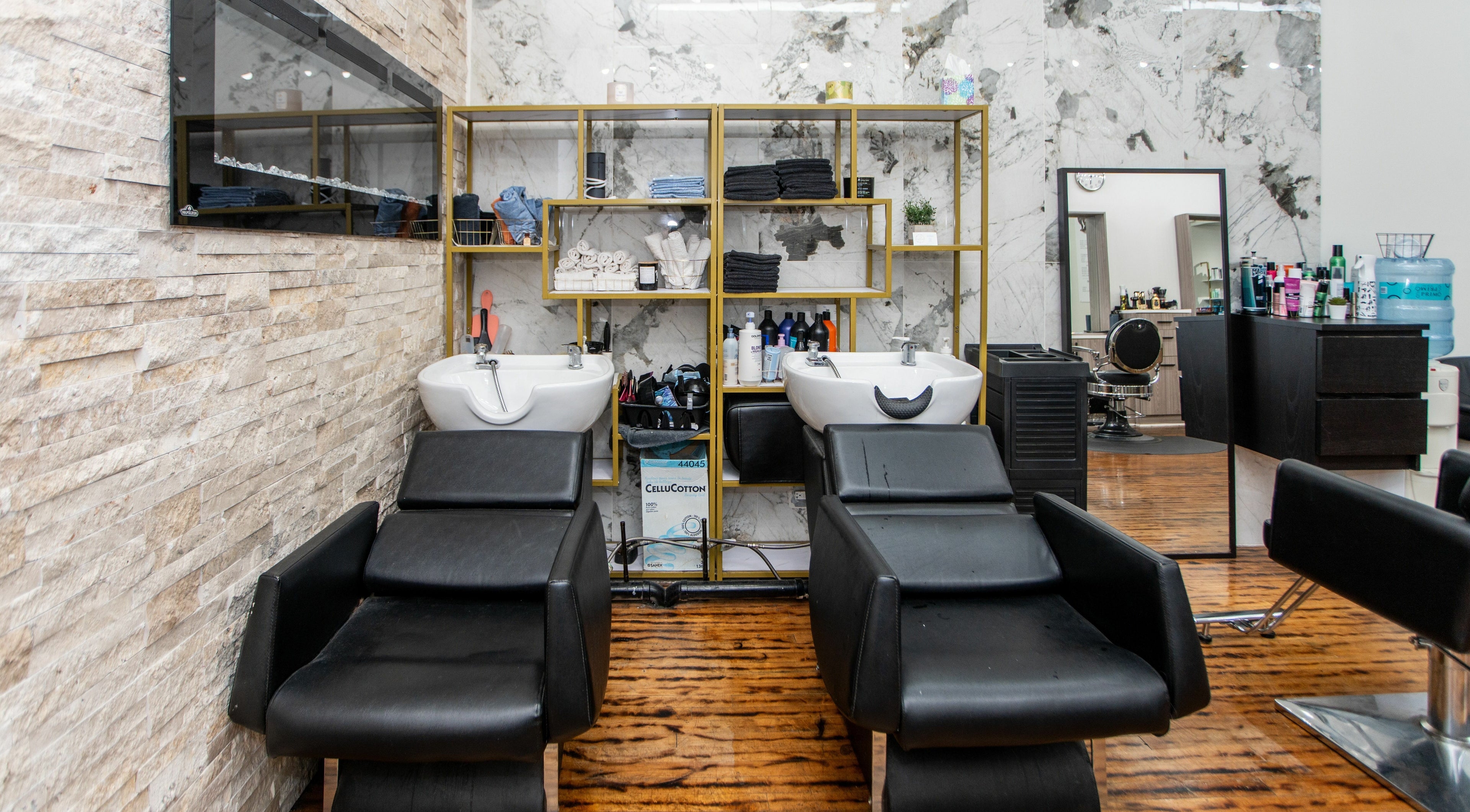 Elegant wash station at Scissor's Palace, Evanston, Illinois, US, with plush chairs and modern design.