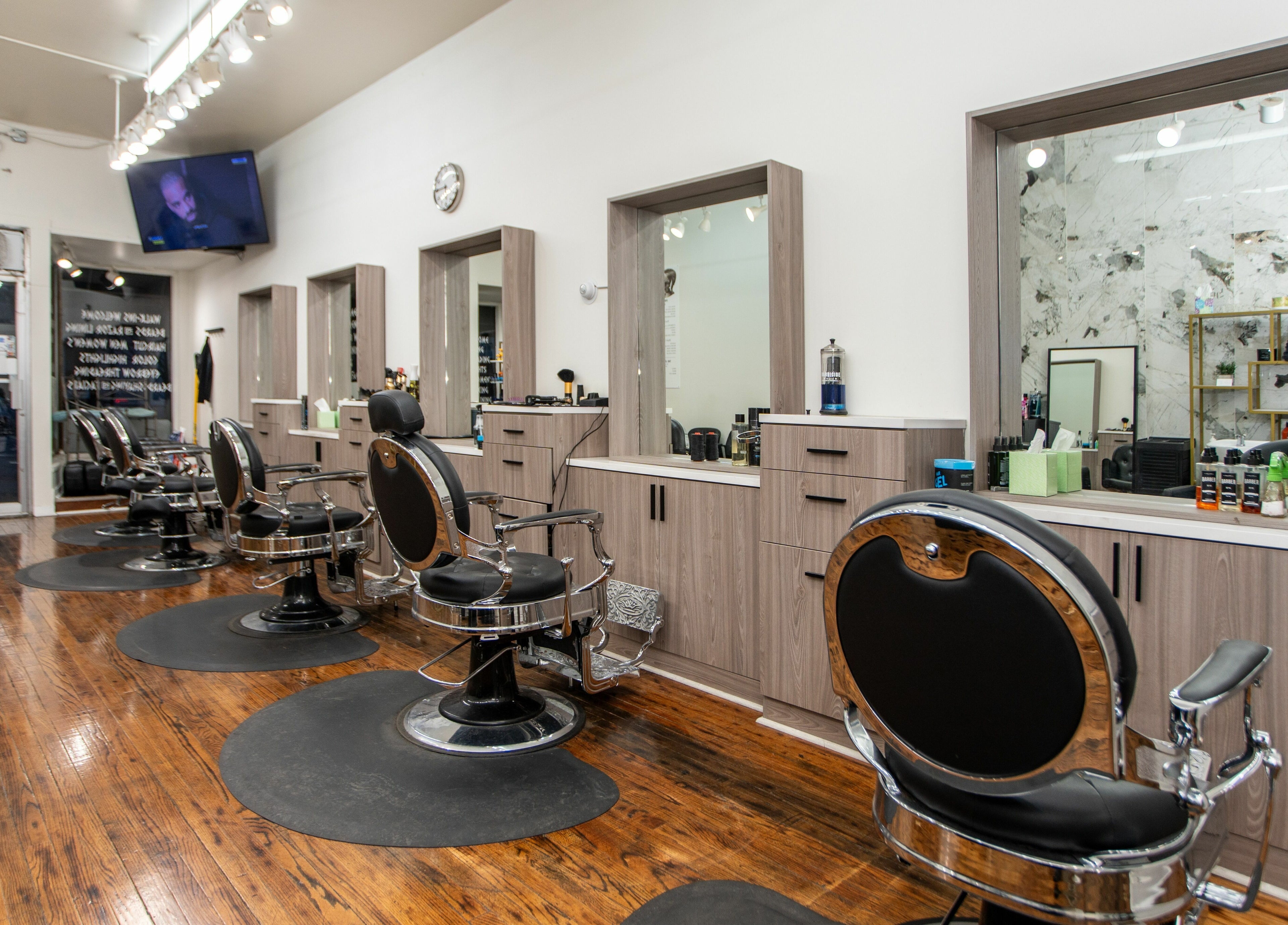Modern salon chairs and mirrors at Scissor's Palace in Evanston, Illinois, US, showcase a stylish ambiance.