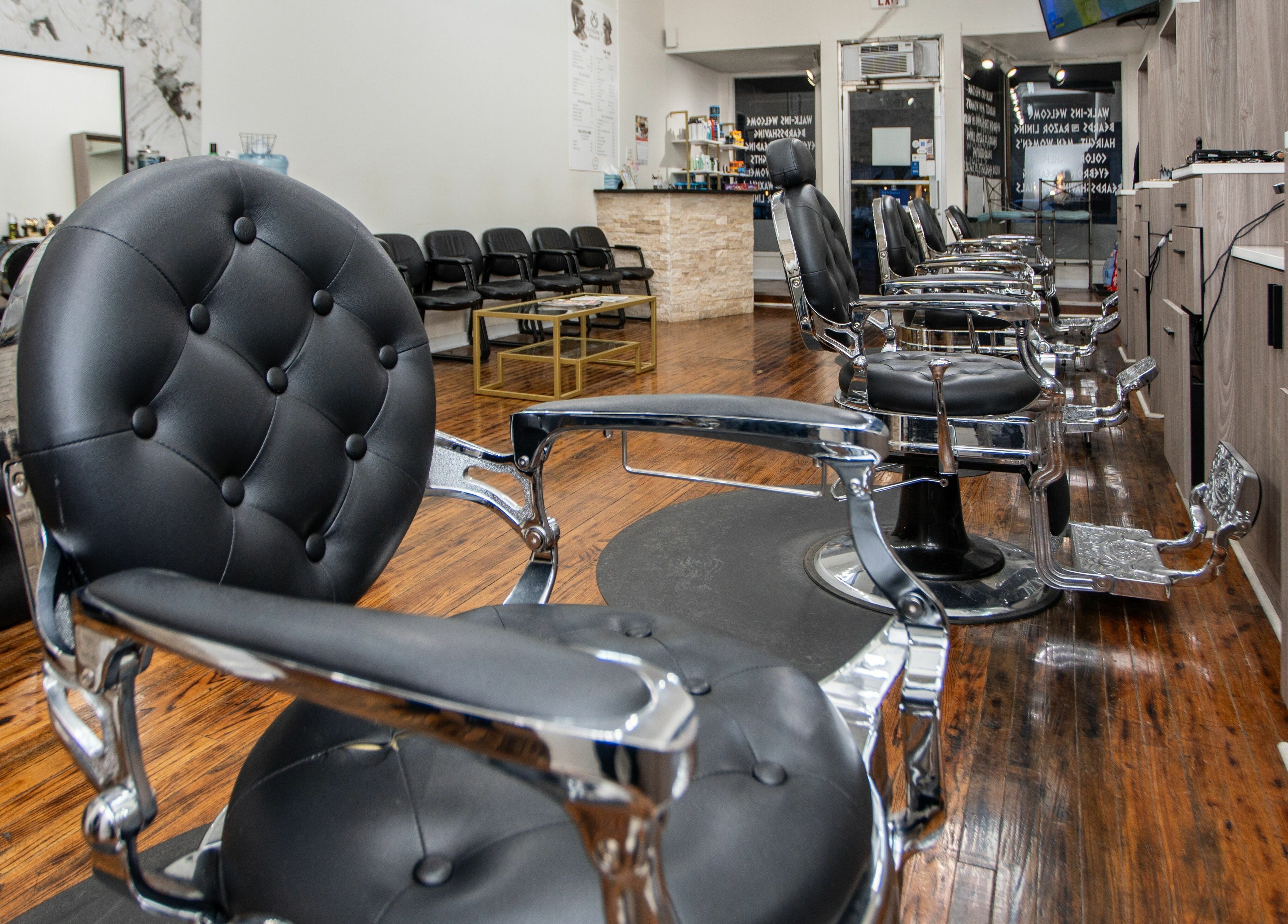 Modern salon interior at Scissor's Palace, Evanston, Illinois, US, featuring elegant black chairs and stylish decor.