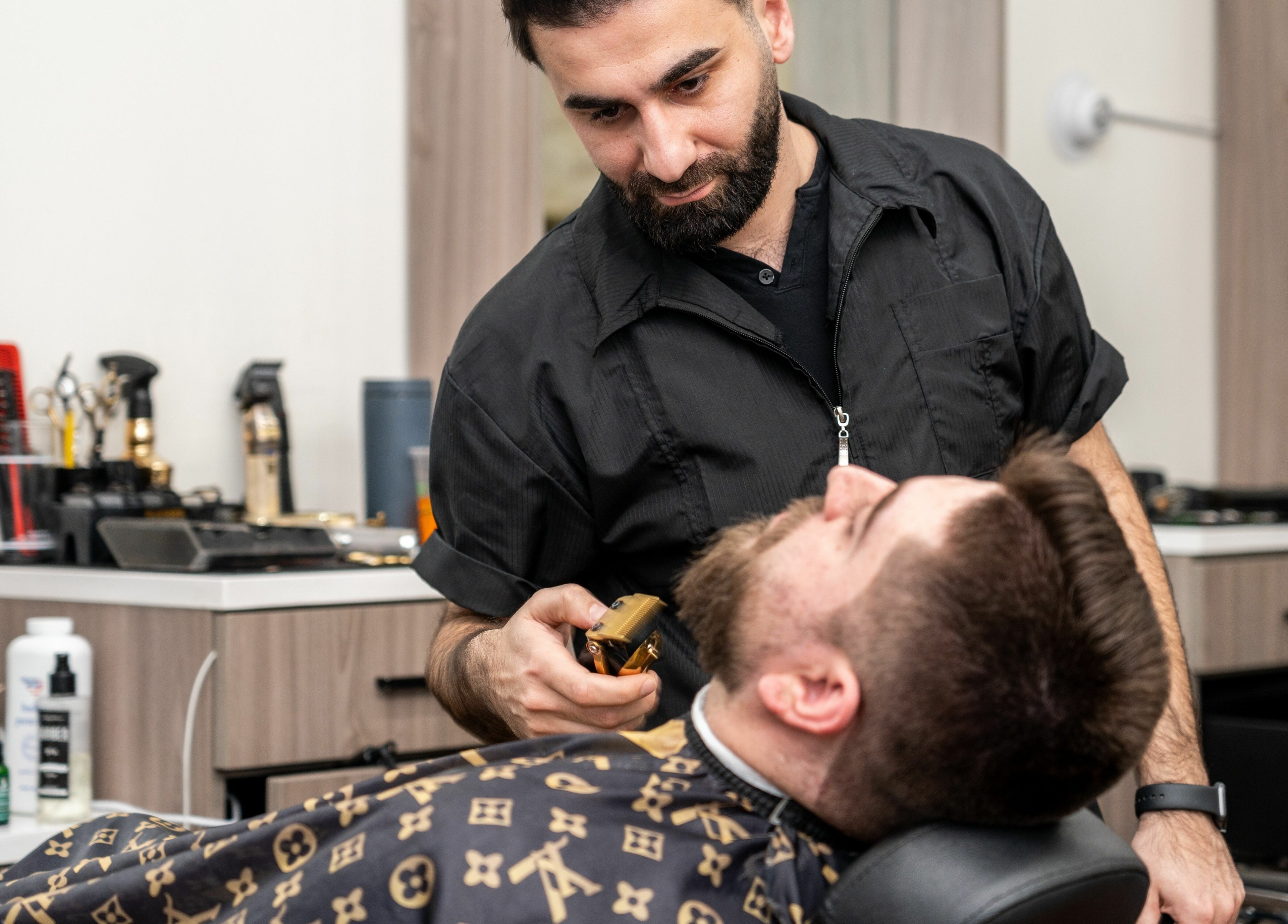 Barber styling a beard at Scissor's Palace in Evanston, Illinois, US with precision and care.