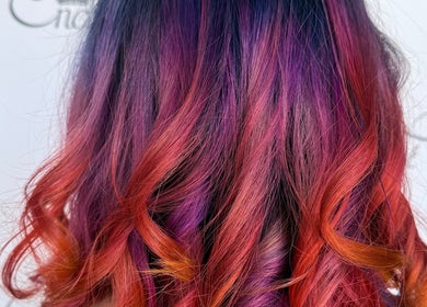 Colorful hair transformation at Enchante Hair Nails Barber, Il-Mosta, MT showcases stunning purple-red waves.