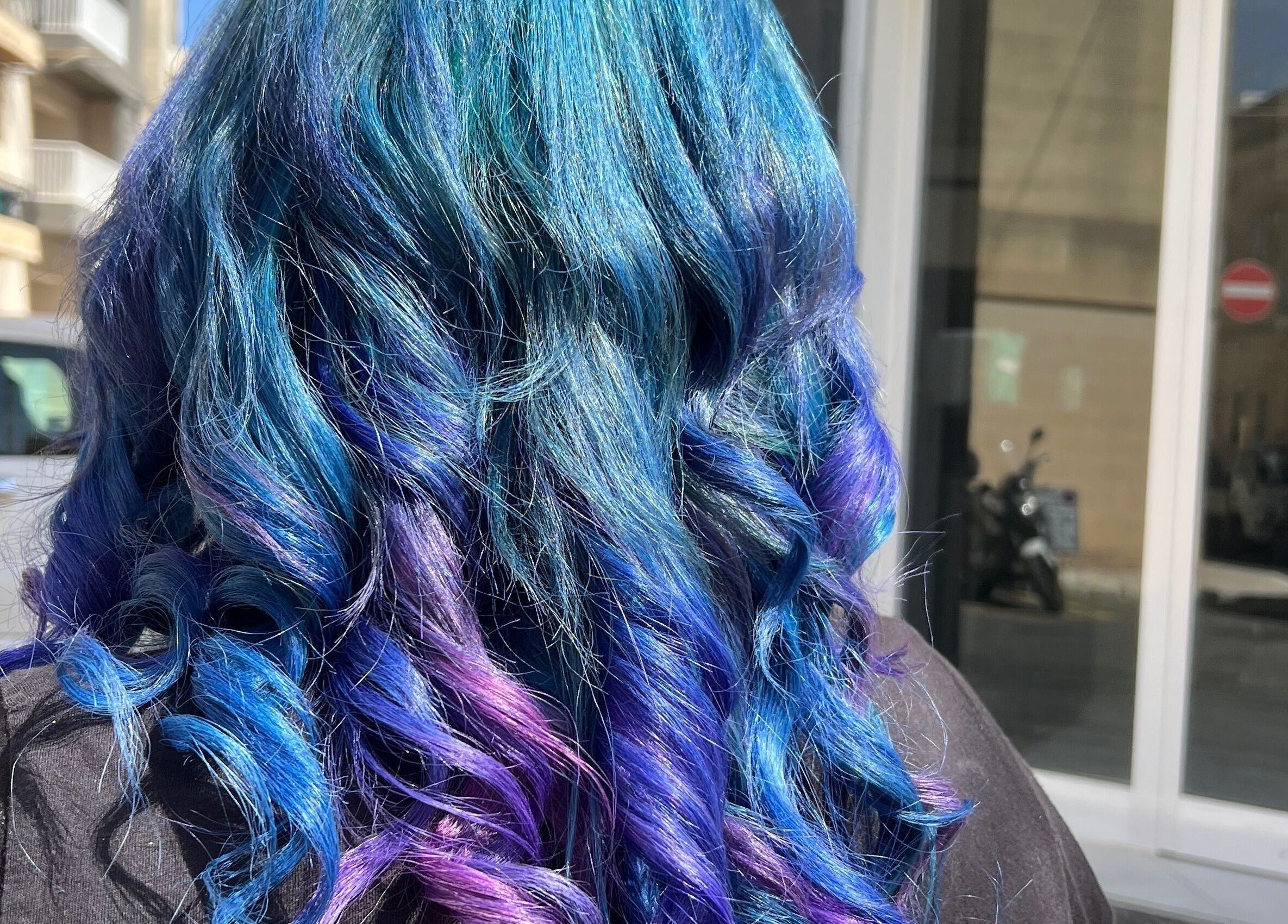 Vibrant blue and purple curls styled at Enchante Hair Team, Il-mosta, MT.