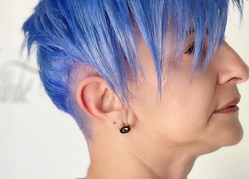 Bold blue haircut at Enchante Hair Team, Il-Mosta, MT, showcasing creative salon expertise.