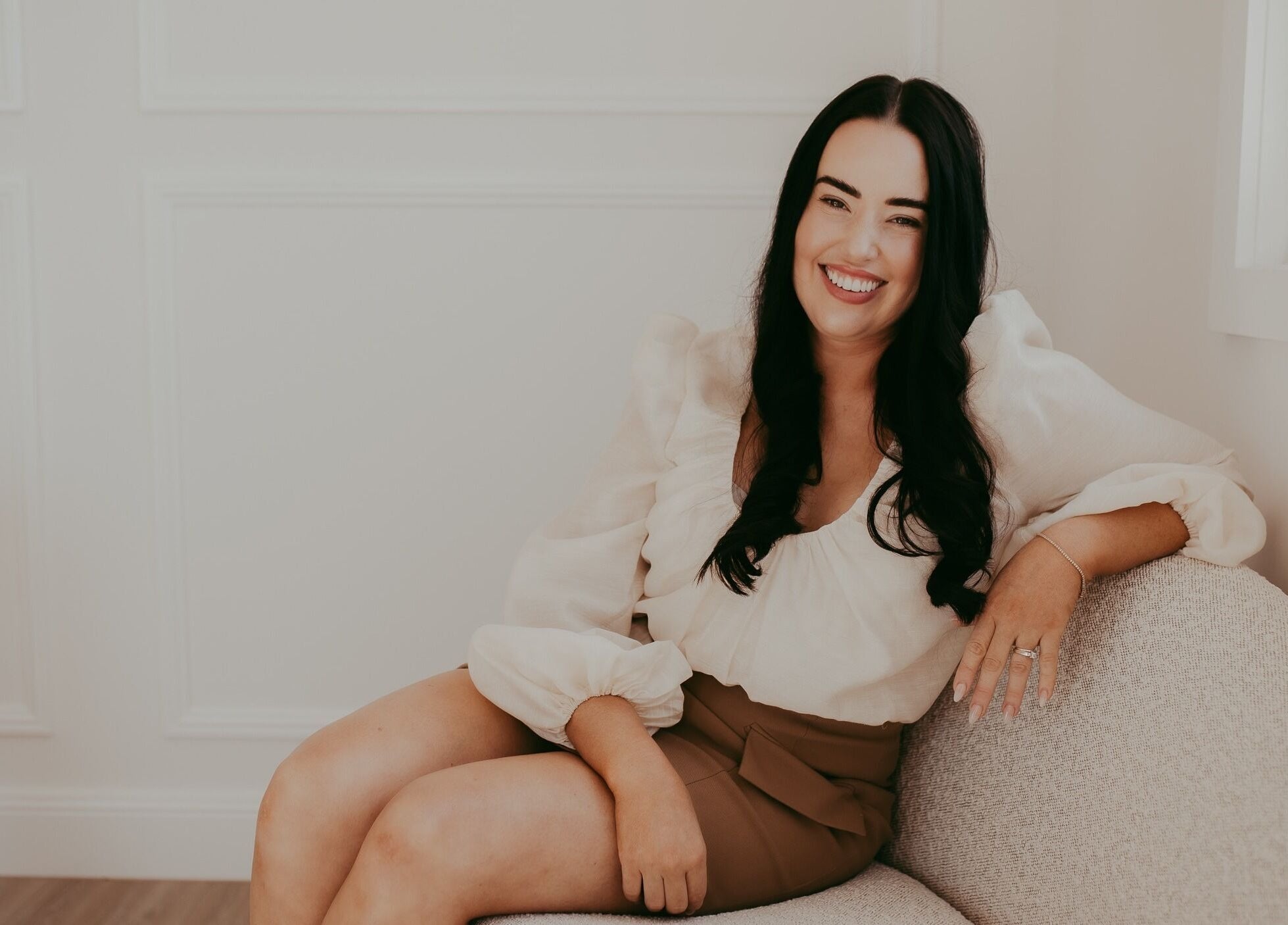 Relaxed woman sitting in Meridian Aesthetics Yarrabilba, Yarrabilba, Queensland, AU, showcasing serene ambiance.