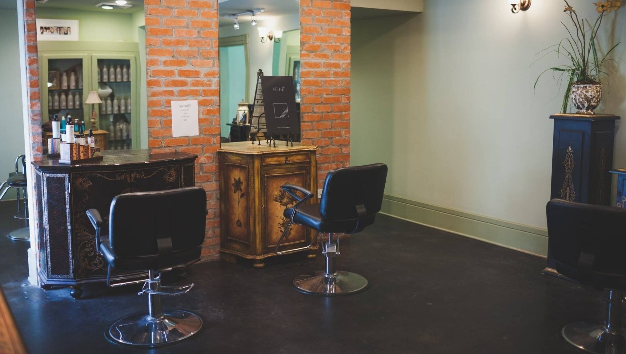 Cozy corner at ROSA' VITA SALON, Beaumont, Texas, US, highlighting elegant chairs and rustic decor.