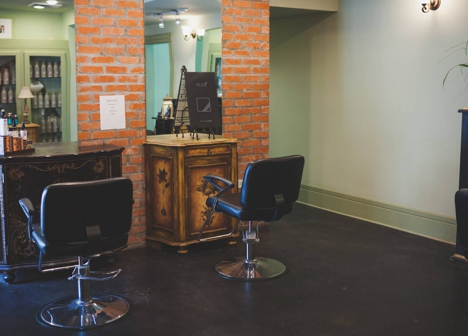 Cozy corner at ROSA' VITA SALON, Beaumont, Texas, US, highlighting elegant chairs and rustic decor.