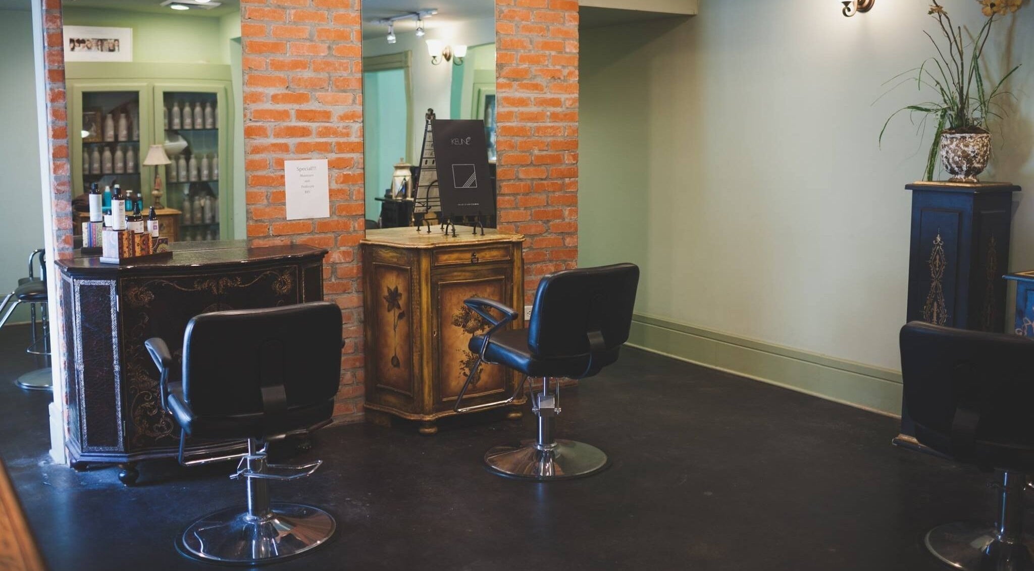 Cozy corner at ROSA' VITA SALON, Beaumont, Texas, US, highlighting elegant chairs and rustic decor.