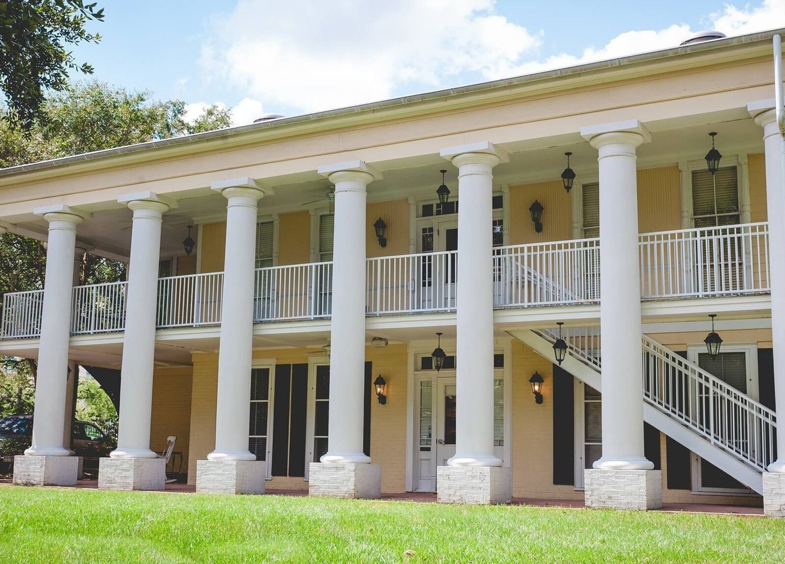 Elegant colonial-style facade of ROSA' VITA SALON in Beaumont, Texas, US, showcasing classic architectural beauty.