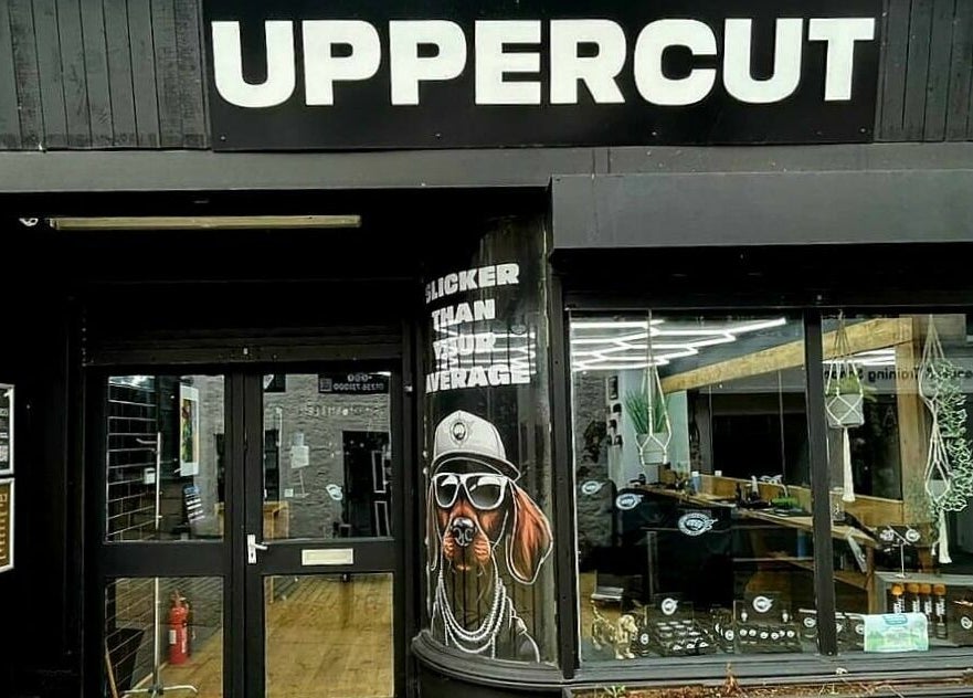 Uppercut storefront in Kilsyth, Scotland, GB with eye-catching mural and signage.