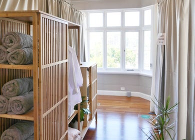 Calming massage room at Alpha Japanese Remedial Massage, Haymarket, New South Wales, AU with towels and plants.