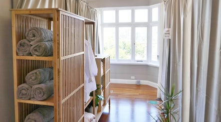 Calming massage room at Alpha Japanese Remedial Massage, Haymarket, New South Wales, AU with towels and plants.