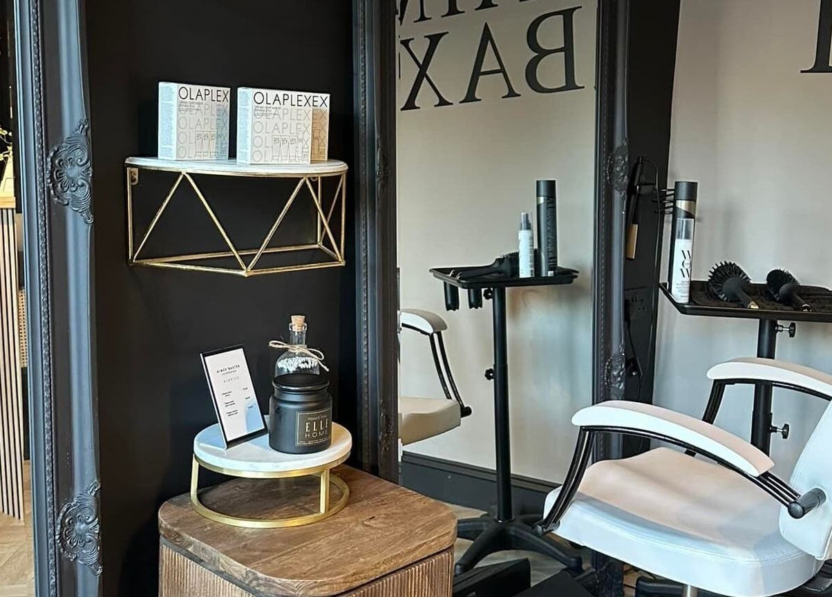 Stylish interior of Aimee Baxter Hairdressing in Cupar, Scotland, GB, featuring a modern salon chair and products.