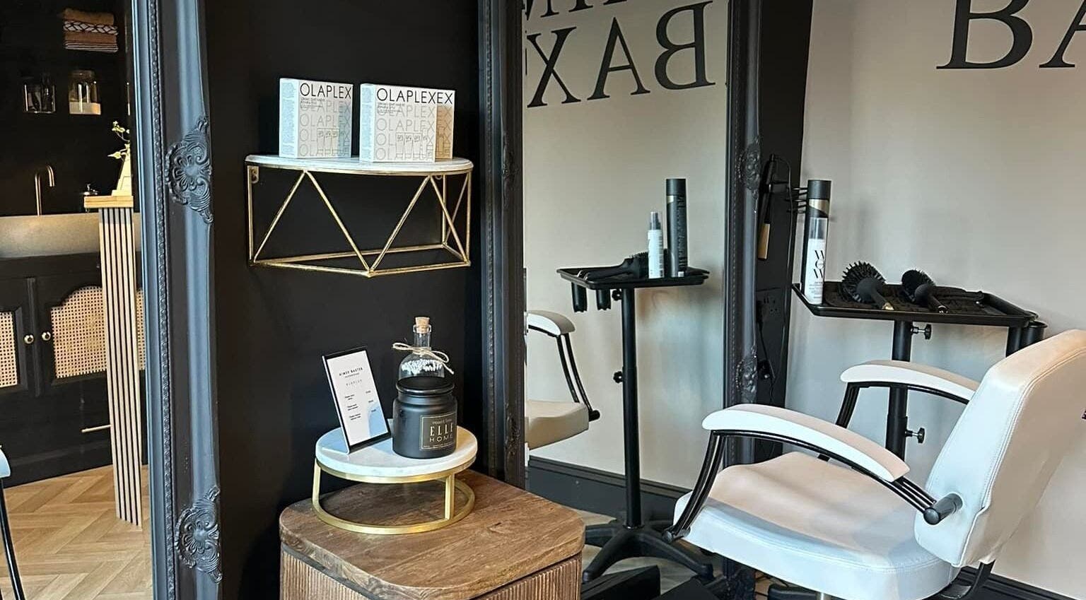 Stylish interior of Aimee Baxter Hairdressing in Cupar, Scotland, GB, featuring a modern salon chair and products.