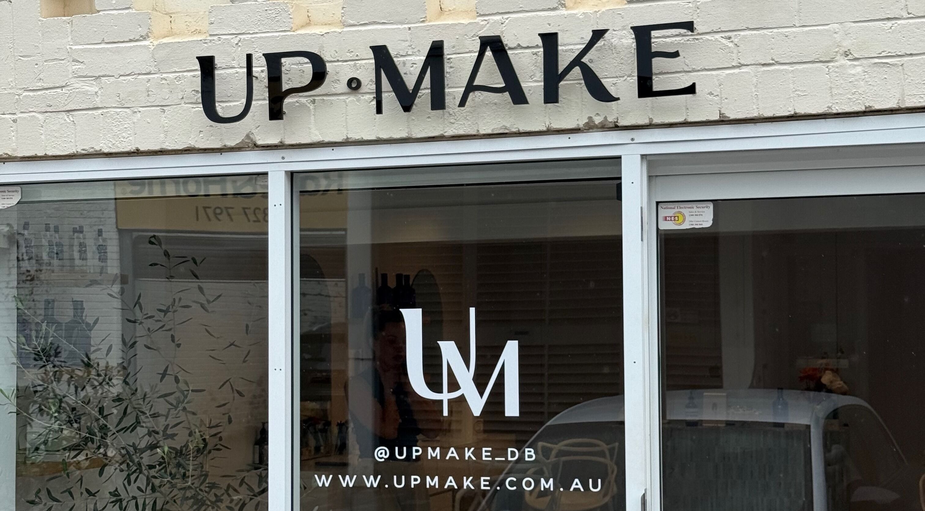 Entrance of Up Make - Double Bay located in Double Bay, New South Wales, AU, showcasing modern signage.